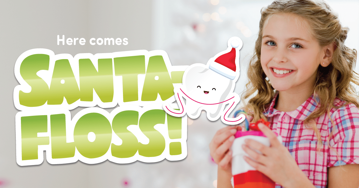 A young blonde girl smiles and holds a drink. The superimposed text reads "Here Comes Santa Floss"