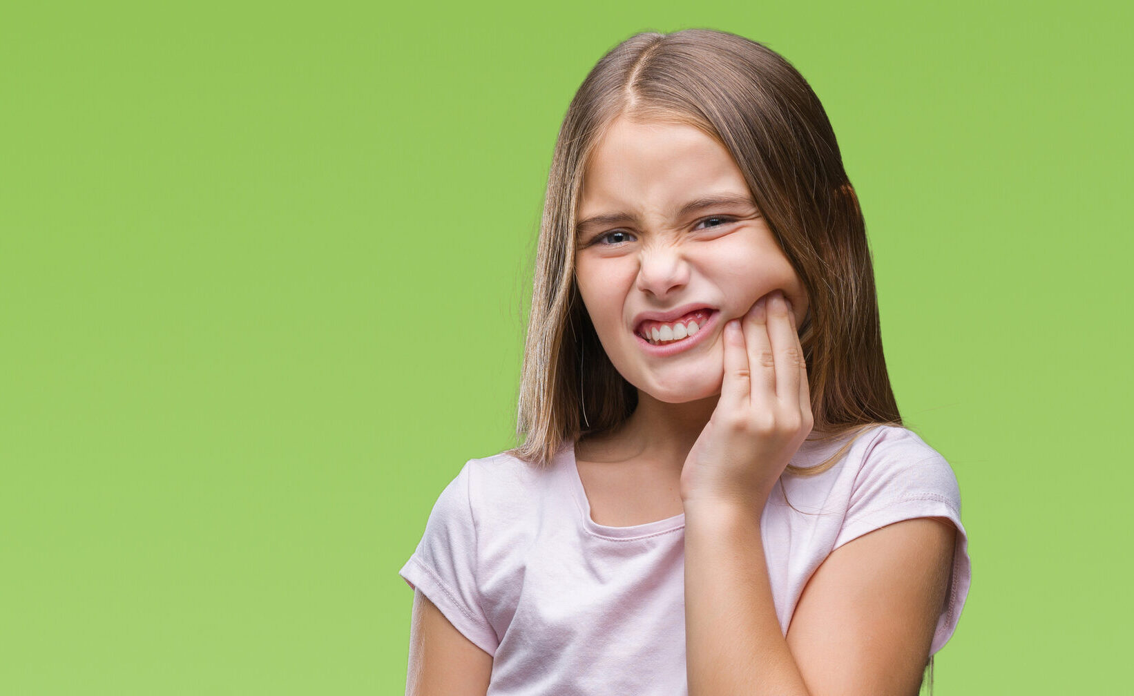 Young beautiful girl over isolated background touching mouth with hand with painful expression because of toothache or dental illness on teeth. Dentist concept.