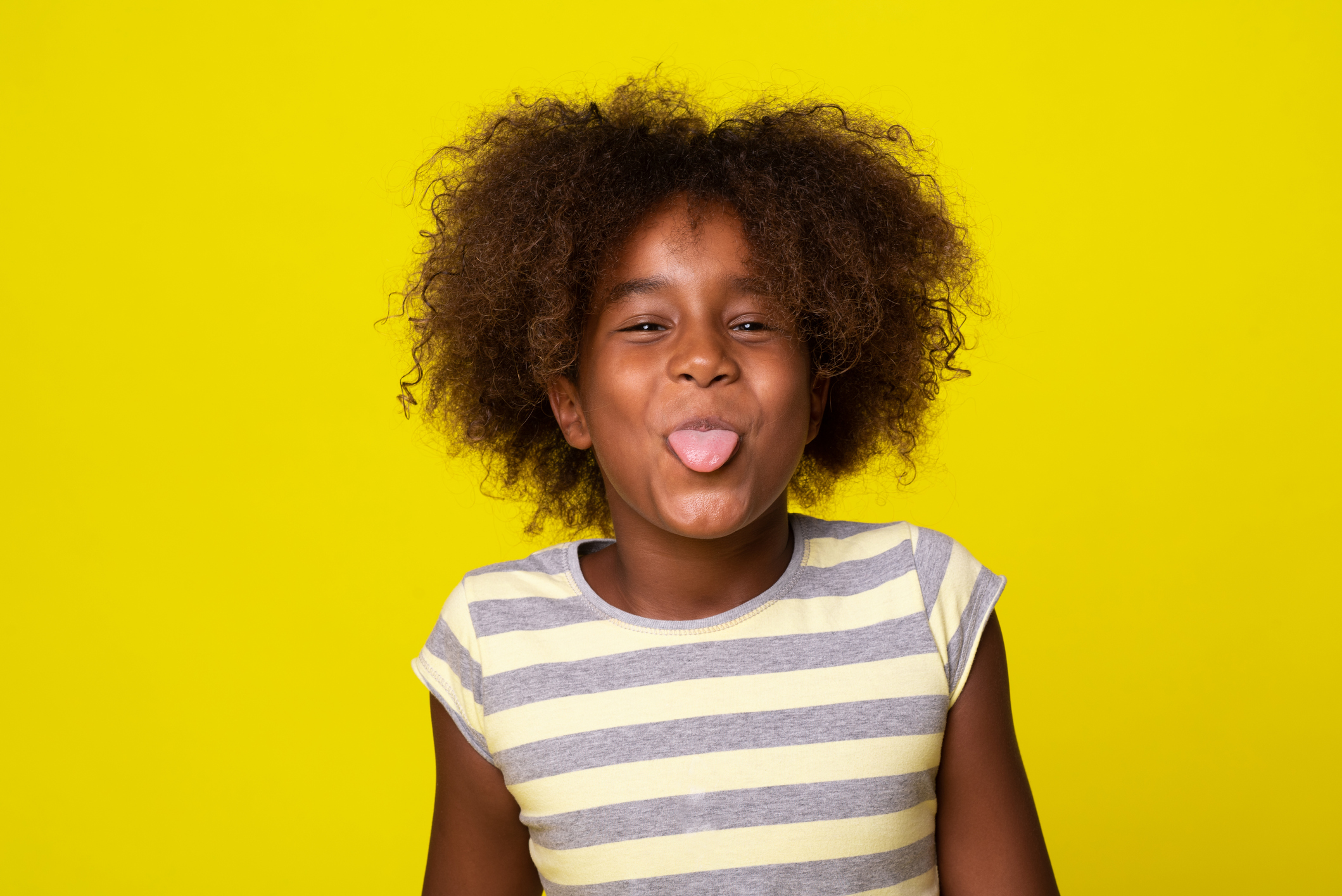 Portrait of a cute girl sticking tongue out